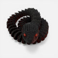 L3D Prints articulated black snake toy with red glow-in-the-dark eyes, a unique sensory toy.