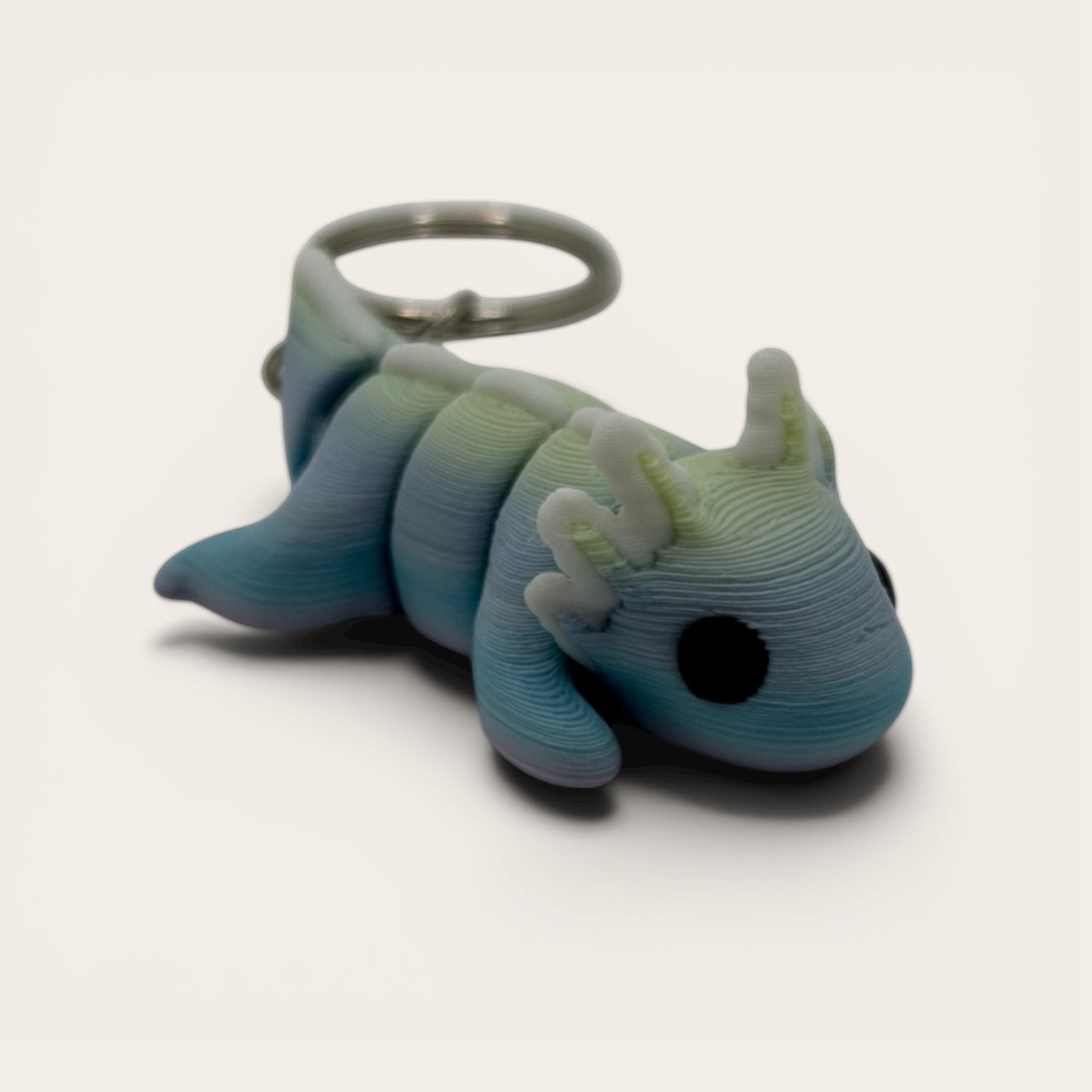 L3D Prints articulated rainbow axolotl keychain, a 3D printed sensory fidget toy with flexible movement.