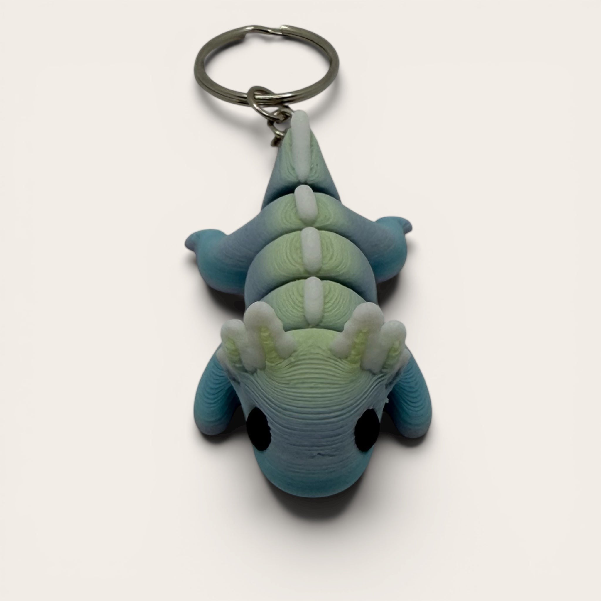 L3D Prints articulated rainbow axolotl keychain, 3D printed with colour-changing filament, flexible and fun fidget toy.
